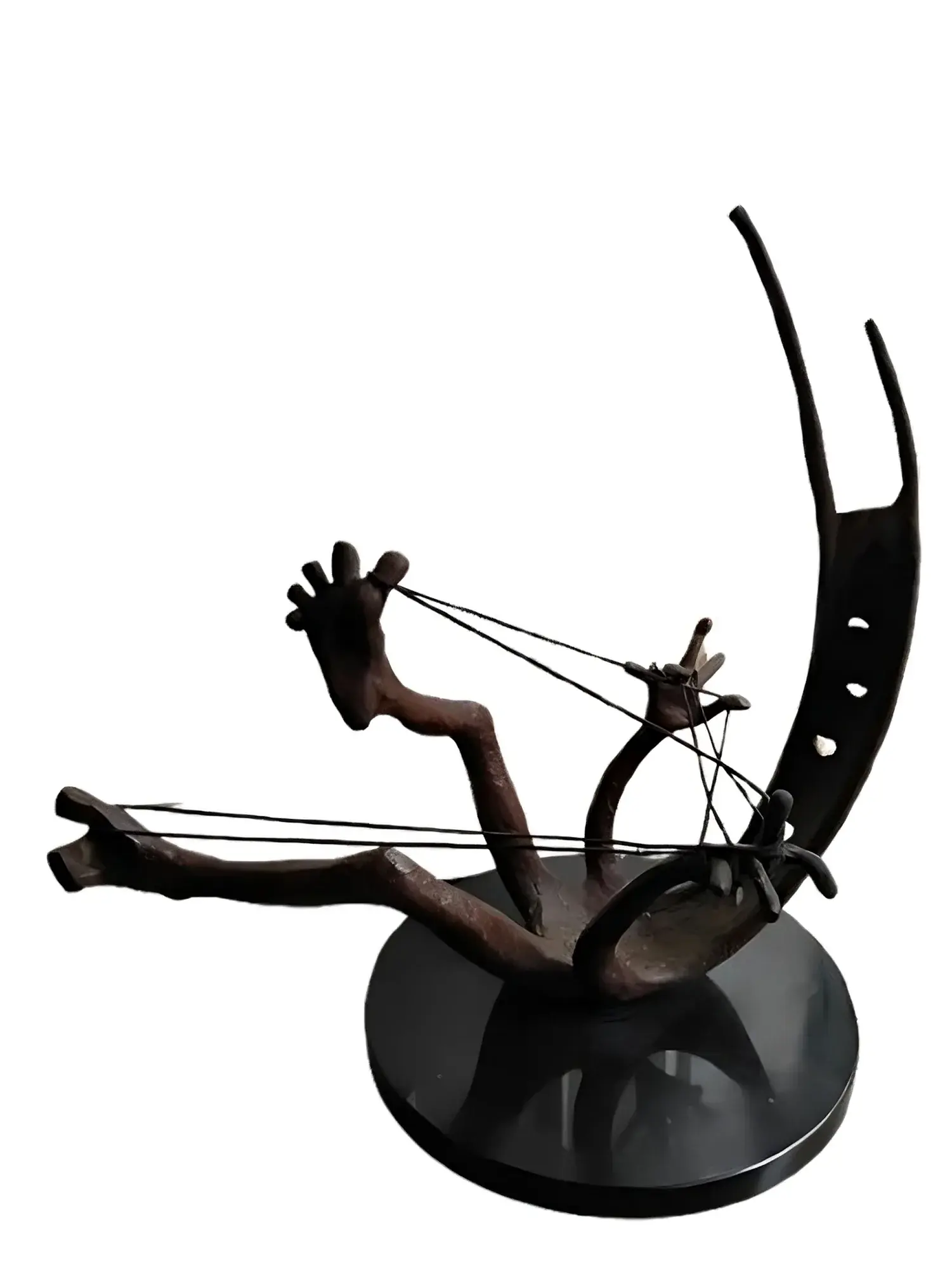 Abstract bronze sculpture, a crescent wing-like form with two small carved hands pulling taut wires, on a round black base