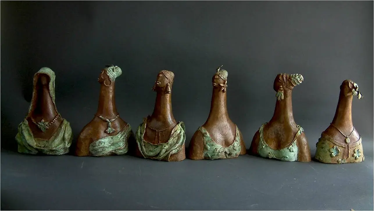Six bronze portrait busts in a row, braided hair, mint-patina bodices, no arms or legs