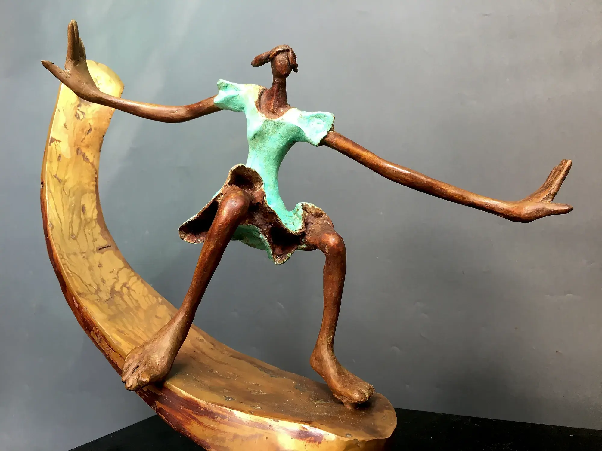 Skiing II — bronze figure balanced on a curved ski, arms outstretched mid-motion